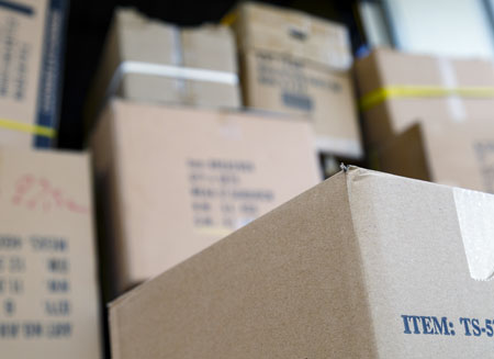 Close up of several cardboard shipping boxes stacking on top of one another.