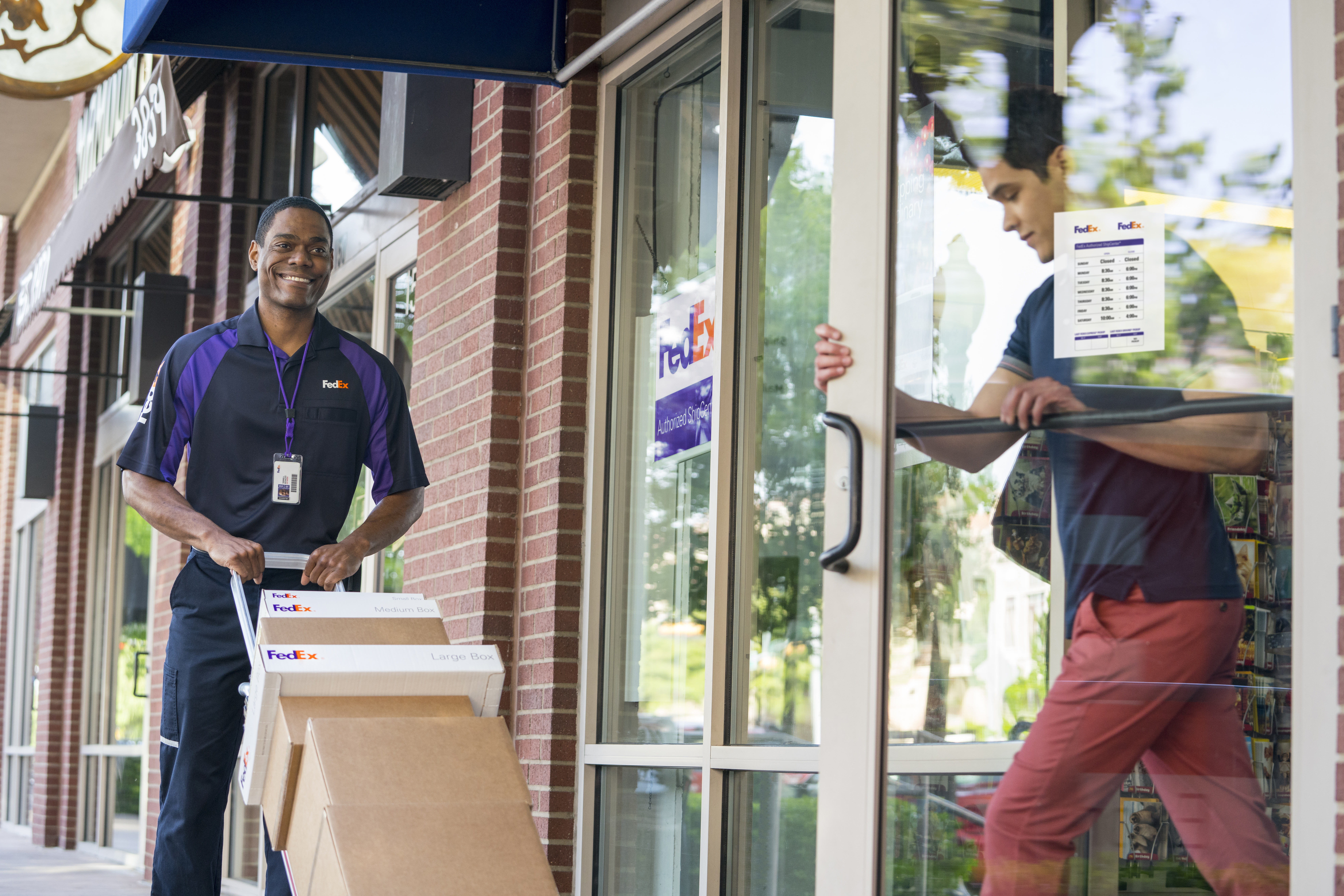FedEx carring stuff into building